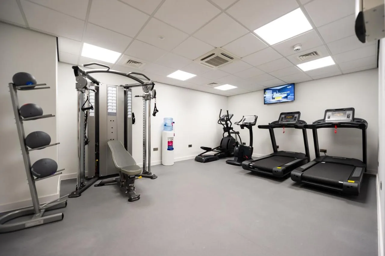 a gym with several treadmills and elliptical machines at Staycity Aparthotels Liverpool Waterfront in Liverpool